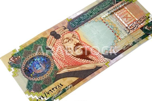 The obverse side of 200 SAR two hundred Saudi Arabia riyal cash money banknote bill, features King Abdulaziz Al Saud, picture of the door of Al-Masmak