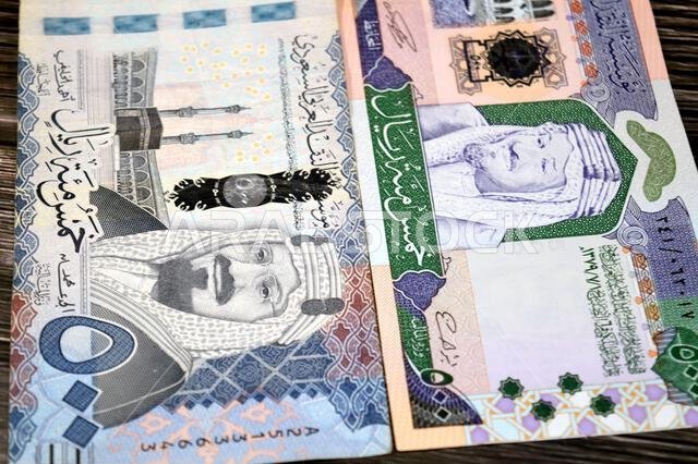 The obverse sides of old and new 500 SAR five hundred Saudi riyals cash money banknote bill, features The Kaaba Ka'aba, inside the Great Mosque of Mec