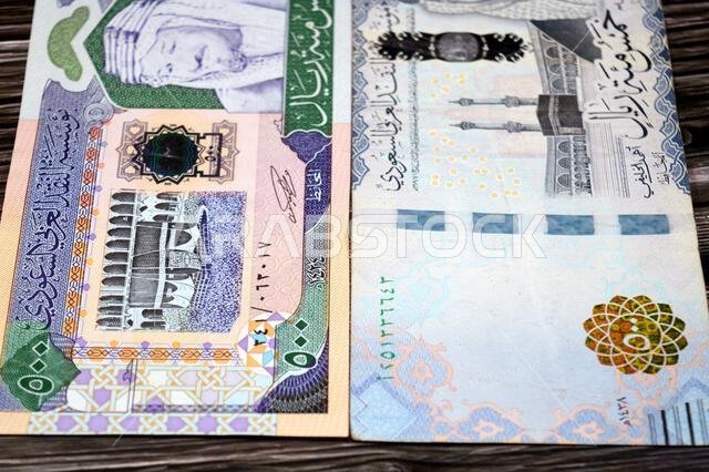 The obverse sides of old and new 500 SAR five hundred Saudi riyals cash money banknote bill, features The Kaaba Ka'aba, inside the Great Mosque of Mec