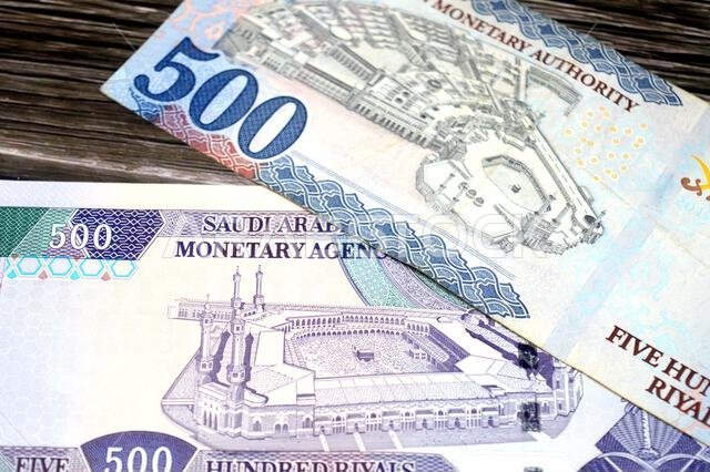 The reverse sides of old and new 500 SAR five hundred Saudi riyals cash money banknote bill, features the Courtyard of The Holy great Mosque in Mecca,