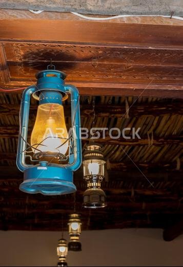 A picture of old lamps hanging for lighting in one of the historic houses in Saudi Arabia.