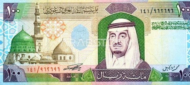 Large fragment of the obverse side of 100 SAR one hundred Saudi Arabian riyals cash money banknote bill, features a portrait of king Fahd Bin AbdulAzi