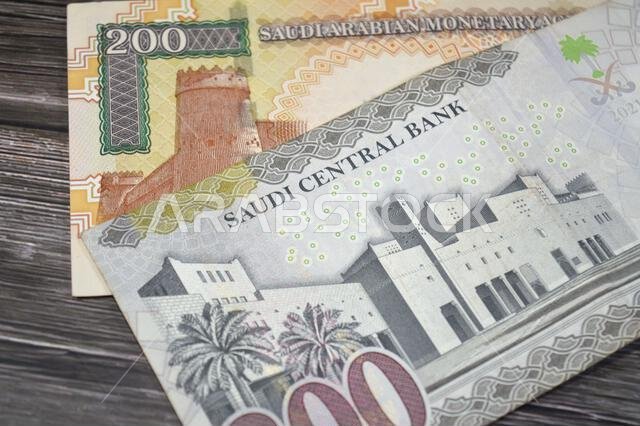 The reverse sides of old and new 200 SAR two hundred Saudi Arabia riyal cash money banknote bill, features Al Masmak Palace and the Qasr Al Hukm in Ri