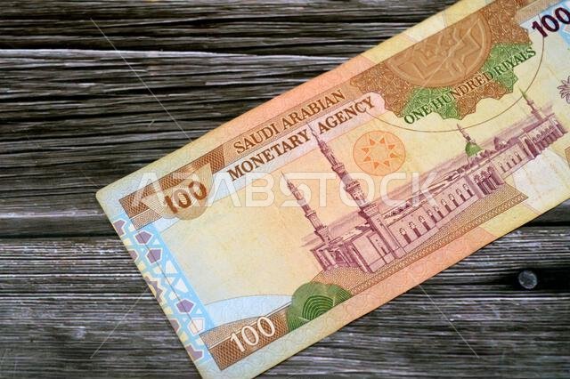 the reverse side of 100 SAR one hundred Saudi Arabian riyals cash money banknote bill, features a general view of the Holy Prophet's Mosque at Madina,