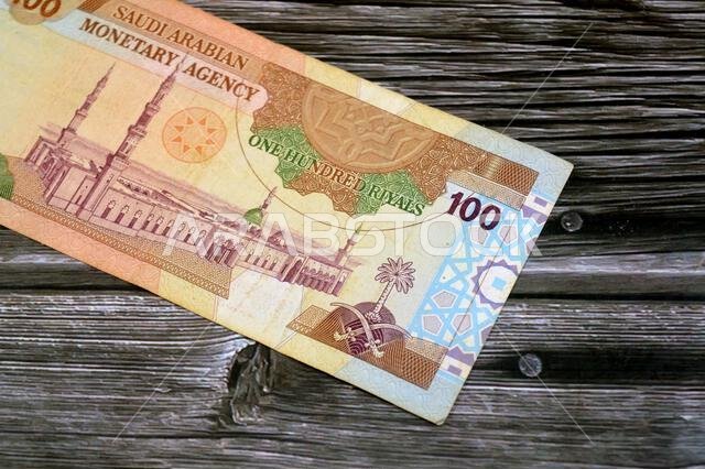 the reverse side of 100 SAR one hundred Saudi Arabian riyals cash money banknote bill, features a general view of the Holy Prophet's Mosque at Madina,