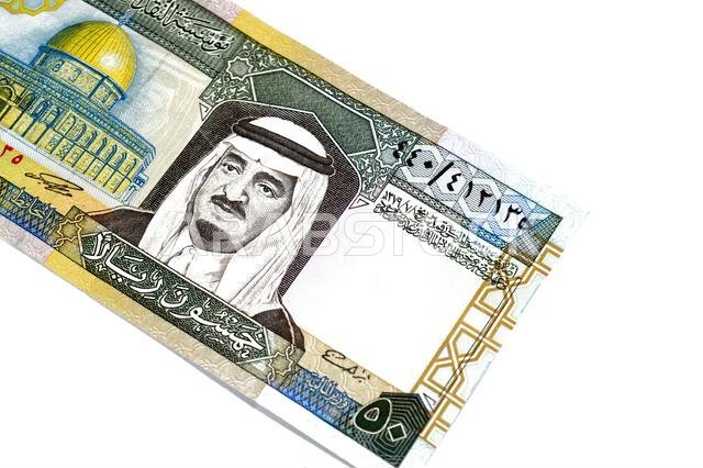 the obverse side of 50 SAR fifty Saudi Arabian riyals cash money banknotes bill, features a portrait of king Fahd Bin AbdulAziz Al Saud and Dome of th