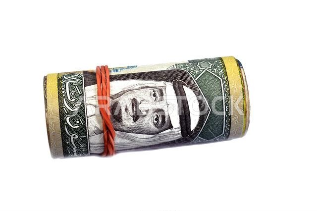 50 SAR fifty Saudi Arabian riyals cash money banknotes bills roll wrapped up with rubber band, features a portrait of king Fahd Bin AbdulAziz Al Saud 50 SAR fifty Saudi Arabian riyals cash money banknotes bills roll wrapped up with rubber band, features a portrait of king Fahd Bin AbdulAziz Al Saud