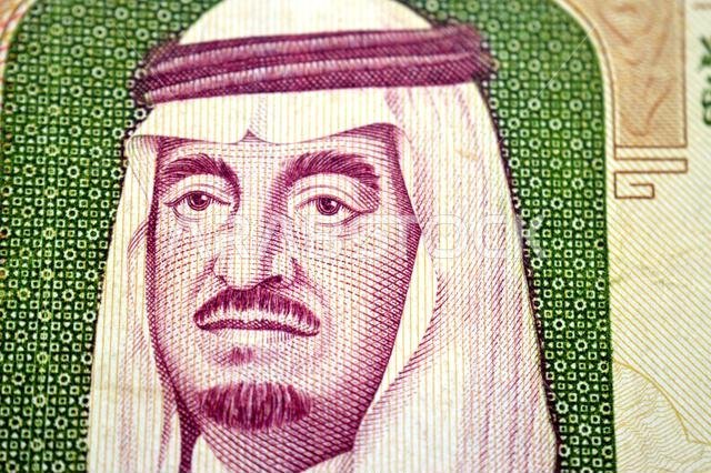 a portrait of king Fahd Bin AbdulAziz from the obverse side of 100 SAR one hundred Saudi Arabian riyals cash money banknote bill, also features the Pr