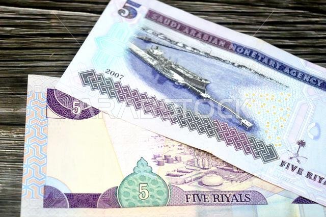 the reverse sides of 5 SAR five Saudi Arabian riyals cash money banknote bill, features Oil refinery, old vintage retro Saudi money from the era of ki