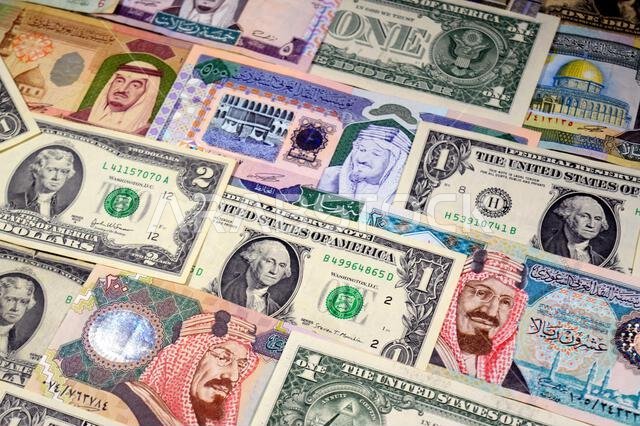 USD American dollars and Saudi Arabian riyals SAR banknotes cash money bills, of different times, eras and values, Saudi Arabia riyals money and Ameri USD American dollars and Saudi Arabian riyals SAR banknotes cash money bills, of different times, eras and values, Saudi Arabia riyals money and Ameri