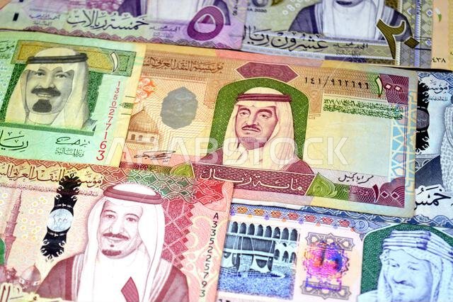 Saudi Arabian riyals SAR banknotes cash money bills, of different times, eras and values, from old vintage retro King Fahd times till king Salman time