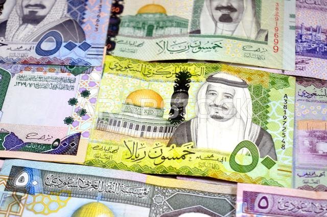 Saudi Arabian riyals SAR banknotes cash money bills, of different times, eras and values, from old vintage retro King Fahd times till king Salman time