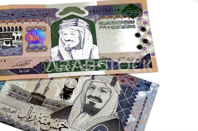 The obverse sides of old and new 500 SAR five hundred Saudi riyals cash money banknote bill, features The Kaaba Ka'aba, inside the Great Mosque of Mec