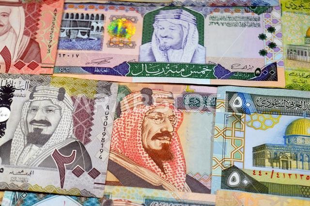 Saudi Arabian riyals SAR banknotes cash money bills, of different times, eras and values, from old vintage retro King Fahd times till king Salman time