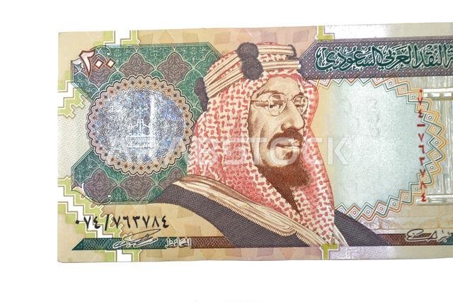 Large fragment of obverse side of 200 SAR two hundred Saudi Arabia riyal cash money banknote bill, features King Abdulaziz Al Saud, picture of the doo