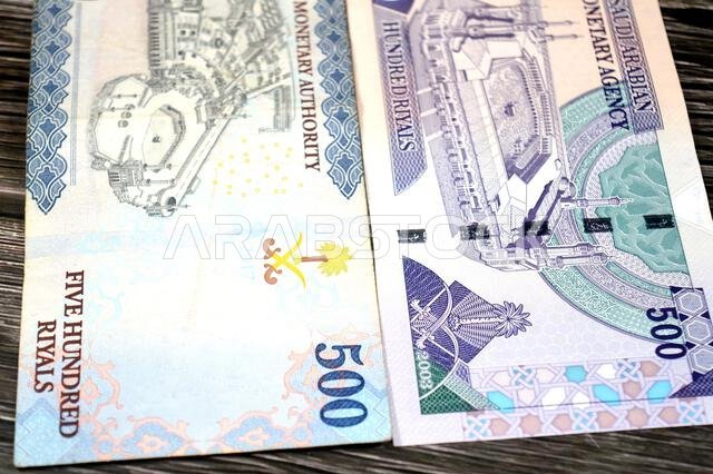 The reverse sides of old and new 500 SAR five hundred Saudi riyals cash money banknote bill, features the Courtyard of The Holy great Mosque in Mecca,