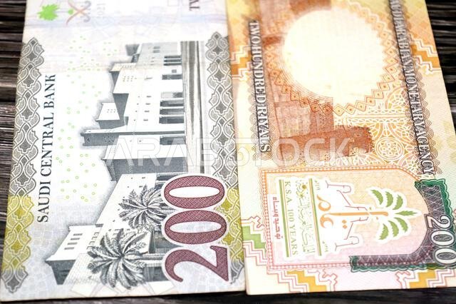 The reverse sides of old and new 200 SAR two hundred Saudi Arabia riyal cash money banknote bill, features Al Masmak Palace and the Qasr Al Hukm in Ri