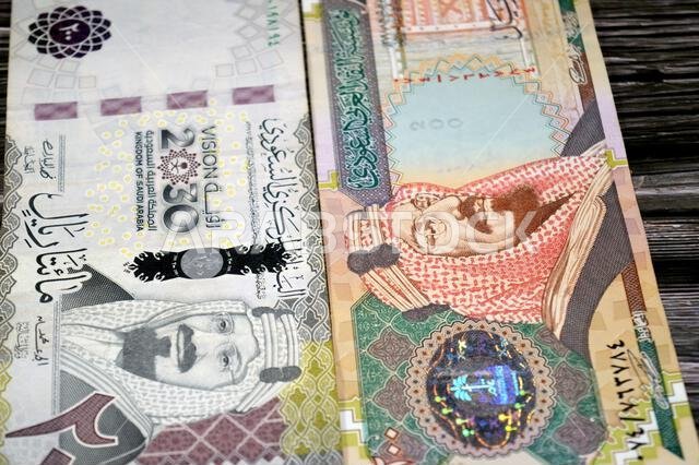 The obverse sides of old and new 200 SAR two hundred Saudi Arabia riyal cash money banknote bill, features King Abdulaziz Al Saud, Saudi Arabian money