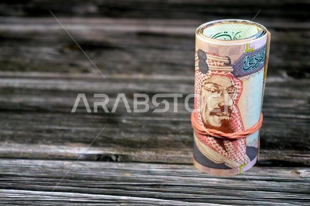 200 SAR two hundred Saudi Arabia riyal cash money banknote bills roll wrapped in a rubber, features King Abdulaziz Al Saud, picture of the door of Al-