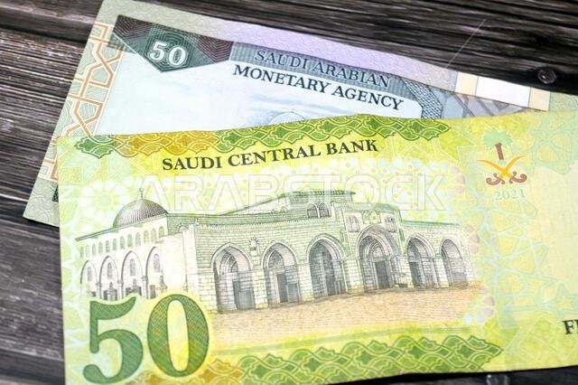 the reverse sides of old and new 50 SAR fifty Saudi Arabian riyals cash money banknotes bill, features Al-Aqsha Mosque in Jerusalem, Saudi Arabia mone the reverse sides of old and new 50 SAR fifty Saudi Arabian riyals cash money banknotes bill, features Al-Aqsha Mosque in Jerusalem, Saudi Arabia mone