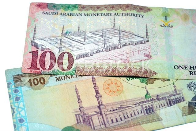 reverse sides of old and new 100 SAR one hundred Saudi Arabian riyals cash money banknote bill, features a general view of the Holy Prophet's Mosque a