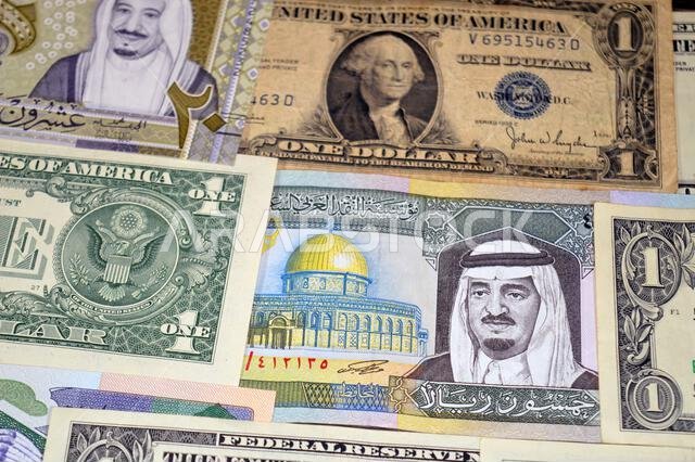 USD American dollars and Saudi Arabian riyals SAR banknotes cash money bills, of different times, eras and values, Saudi Arabia riyals money and Ameri