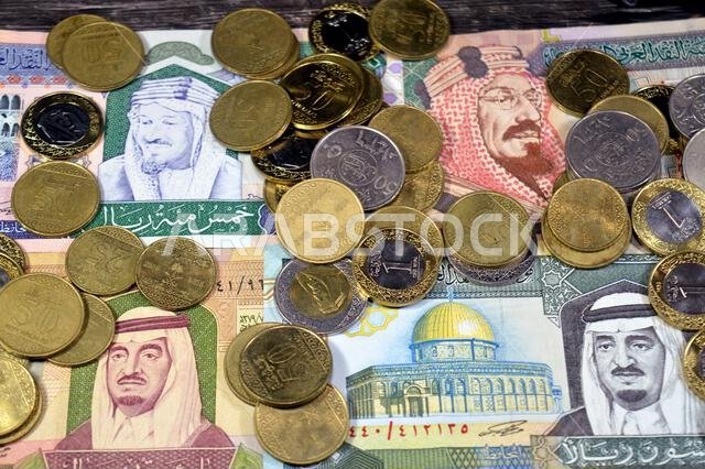 Saudi Arabian riyals SAR coins and banknotes cash money bills, of different times, eras and values, Saudi Arabia riyals money coin and banknote concep