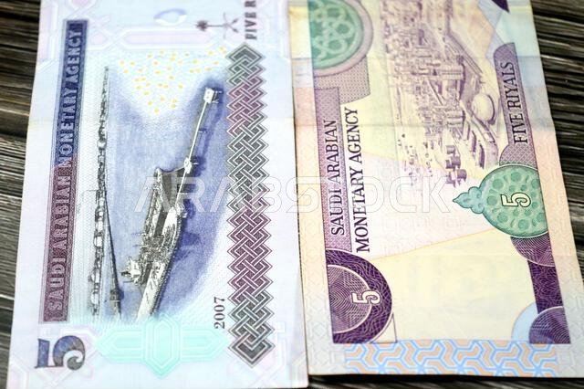 the reverse sides of 5 SAR five Saudi Arabian riyals cash money banknote bill, features Oil refinery, old vintage retro Saudi money from the era of ki