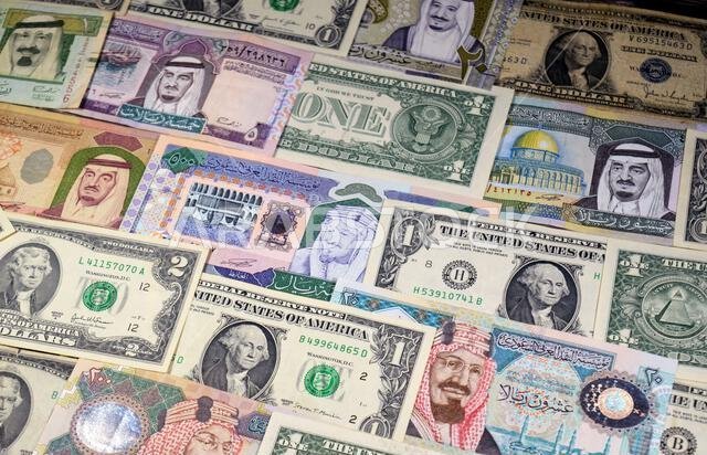 USD American dollars and Saudi Arabian riyals SAR banknotes cash money bills, of different times, eras and values, Saudi Arabia riyals money and Ameri