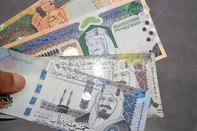The Saudi Arabian riyals SAR banknotes cash money bills, of different times, eras and values, from old vintage retro King Fahd times till king Salman