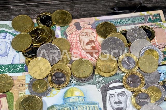 Saudi Arabian riyals SAR coins and banknotes cash money bills, of different times, eras and values, Saudi Arabia riyals money coin and banknote concep