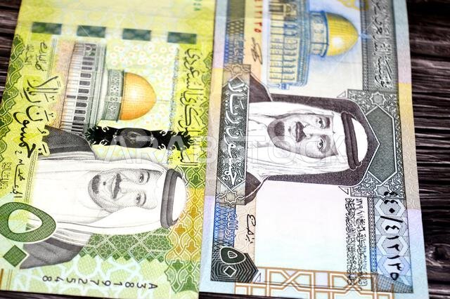 the obverse sides of 50 SAR fifty Saudi Arabian riyals cash money banknotes bills, features king Fahd and king Salman Bin AbdulAziz Al Saud and Dome o the obverse sides of 50 SAR fifty Saudi Arabian riyals cash money banknotes bills, features king Fahd and king Salman Bin AbdulAziz Al Saud and Dome o