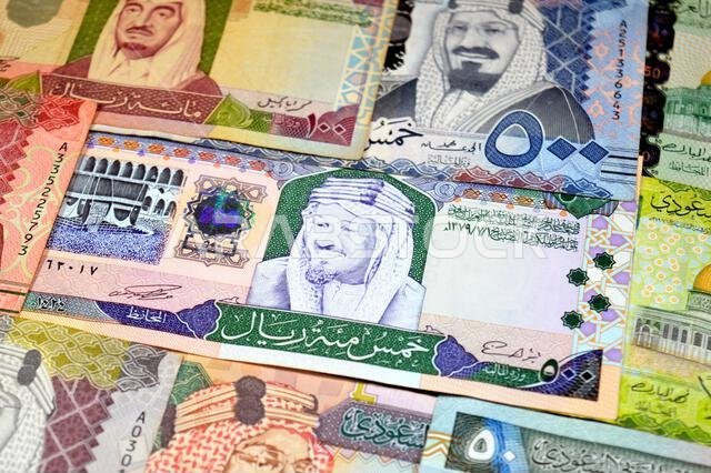 Saudi Arabian riyals SAR banknotes cash money bills, of different times, eras and values, from old vintage retro King Fahd times till king Salman time