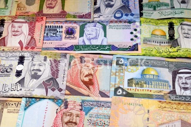 Saudi Arabian riyals SAR banknotes cash money bills, of different times, eras and values, from old vintage retro King Fahd times till king Salman time