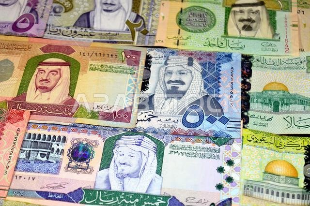 Saudi Arabian riyals SAR banknotes cash money bills, of different times, eras and values, from old vintage retro King Fahd times till king Salman time