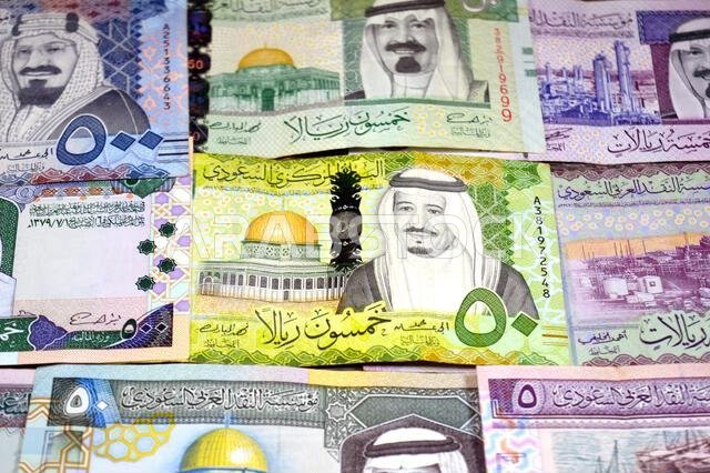Saudi Arabian riyals SAR banknotes cash money bills, of different times, eras and values, from old vintage retro King Fahd times till king Salman time