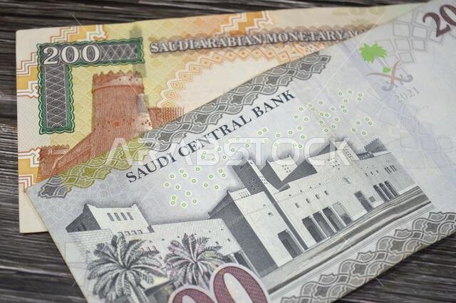The reverse sides of old and new 200 SAR two hundred Saudi Arabia riyal cash money banknote bill, features Al Masmak Palace and the Qasr Al Hukm in Ri