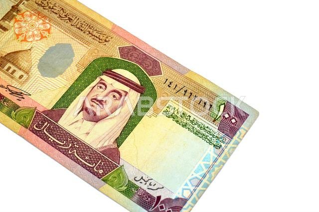 the obverse side of 100 SAR one hundred Saudi Arabian riyals cash money banknote bill, features a portrait of king Fahd Bin AbdulAziz and the Prophet'