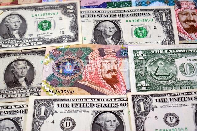 USD American dollars and Saudi Arabian riyals SAR banknotes cash money bills, of different times, eras and values, Saudi Arabia riyals money and Ameri USD American dollars and Saudi Arabian riyals SAR banknotes cash money bills, of different times, eras and values, Saudi Arabia riyals money and Ameri