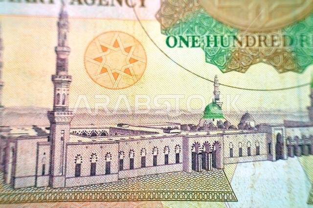 a general view of the Holy Prophet's Mosque at Madina from the reverse side of 100 SAR one hundred Saudi Arabian riyals cash money banknote bill, old a general view of the Holy Prophet's Mosque at Madina from the reverse side of 100 SAR one hundred Saudi Arabian riyals cash money banknote bill, old