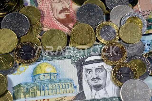 Saudi Arabian riyals SAR coins and banknotes cash money bills, of different times, eras and values, Saudi Arabia riyals money coin and banknote concep Saudi Arabian riyals SAR coins and banknotes cash money bills, of different times, eras and values, Saudi Arabia riyals money coin and banknote concep
