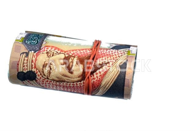 200 SAR two hundred Saudi Arabia riyal cash money banknote bills roll wrapped in a rubber, features King Abdulaziz Al Saud, picture of the door of Al-