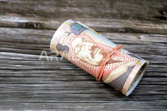200 SAR two hundred Saudi Arabia riyal cash money banknote bills roll wrapped in a rubber, features King Abdulaziz Al Saud, picture of the door of Al-