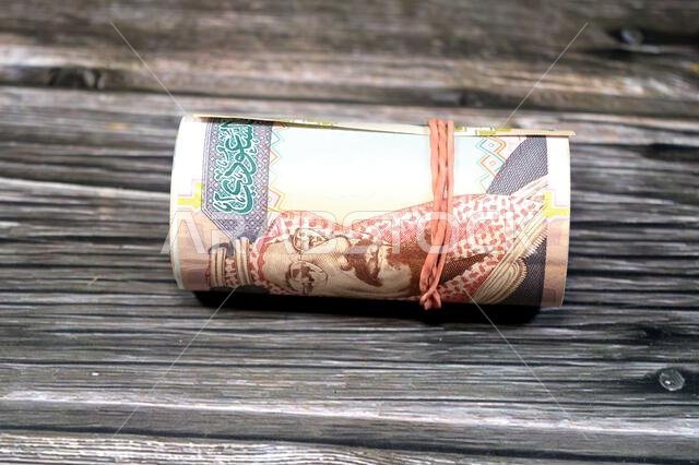 200 SAR two hundred Saudi Arabia riyal cash money banknote bills roll wrapped in a rubber, features King Abdulaziz Al Saud, picture of the door of Al-