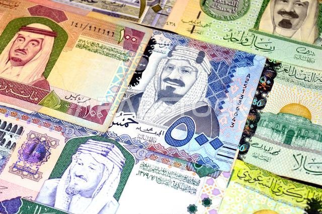 Saudi Arabian riyals SAR banknotes cash money bills, of different times, eras and values, from old vintage retro King Fahd times till king Salman time