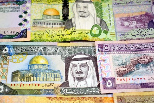 Saudi Arabian riyals SAR banknotes cash money bills, of different times, eras and values, from old vintage retro King Fahd times till king Salman time