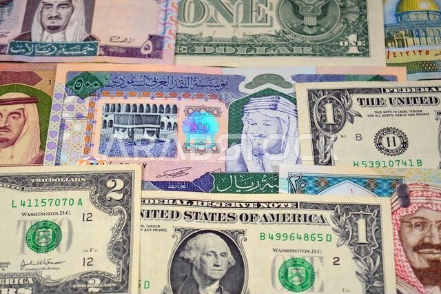 USD American dollars and Saudi Arabian riyals SAR banknotes cash money bills, of different times, eras and values, Saudi Arabia riyals money and Ameri