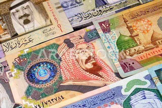 Background of Saudi Arabian riyals SAR banknotes cash money bills, of different ties, eras and values, from old vintage retro King Fahd times till kin