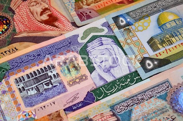 Background of Saudi Arabian riyals SAR banknotes cash money bills, of different ties, eras and values, from old vintage retro King Fahd times till kin