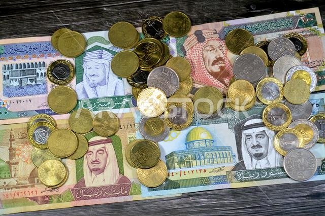 Saudi Arabian riyals SAR coins and banknotes cash money bills, of different times, eras and values, Saudi Arabia riyals money coin and banknote concep